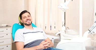 Man in dental hair with brown hair smiling