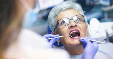 Mature woman having a dental examination. 